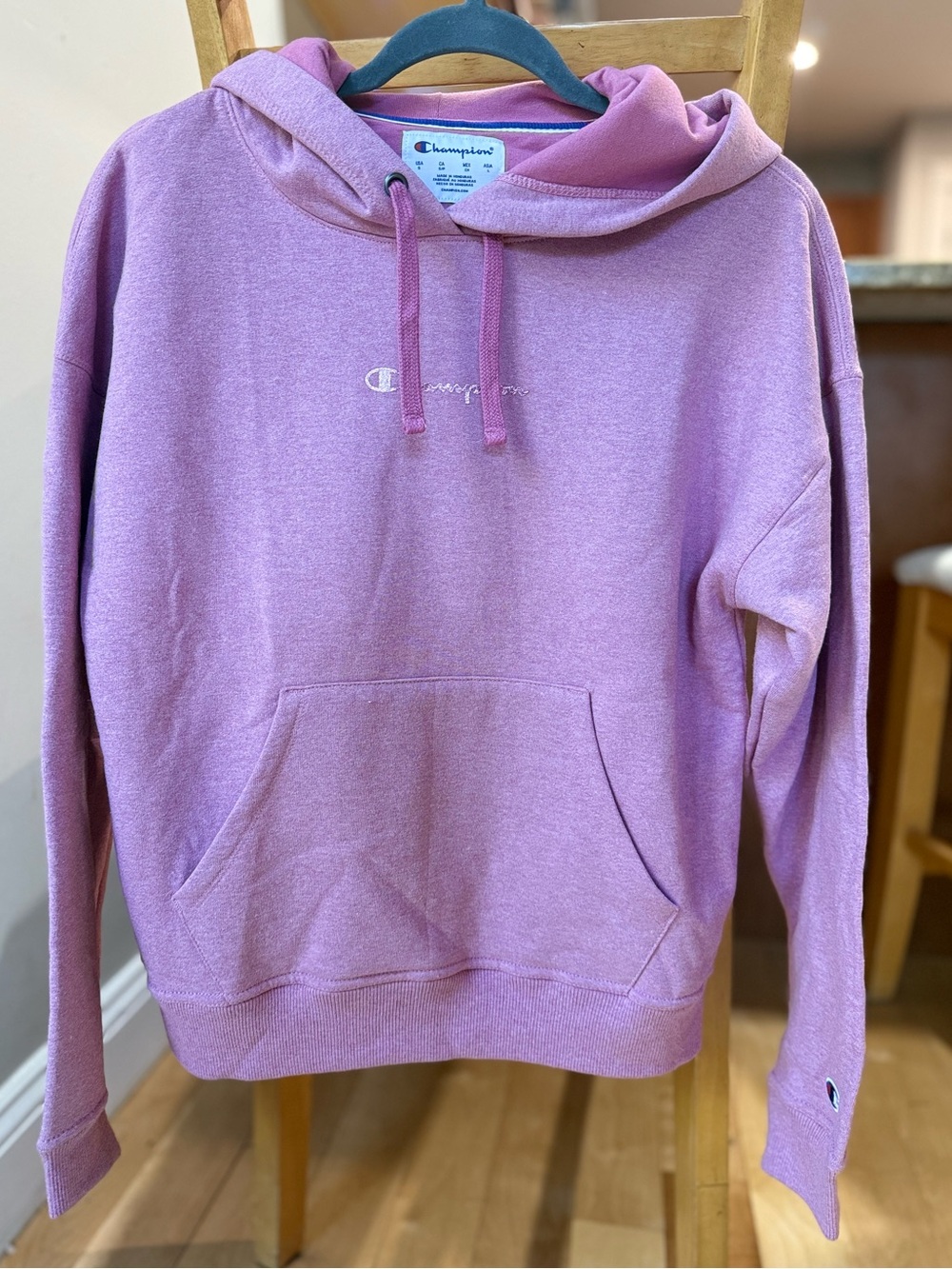 Champion Pink Pullover Hoodie with Metallic Graphic writing.
